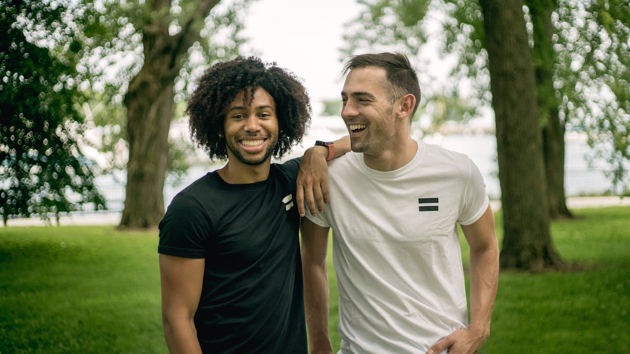 Two men standing on a grass field