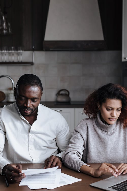 an African American couple paying their bills online