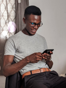 an African American man using his smartphone